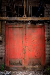 Fototapeta na wymiar Gray steel wall with the red door