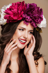 beautiful smiling woman with bright flowers on her head.