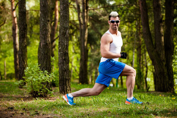 sport man stretching at the park - fitness concepts