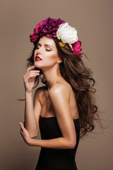 sexy model with curle hair and bright flowers on her head