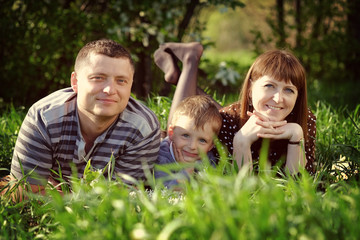 Happy family resting on the grass