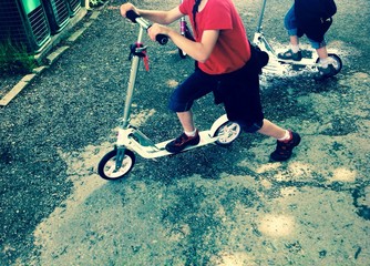 girls riding scooter