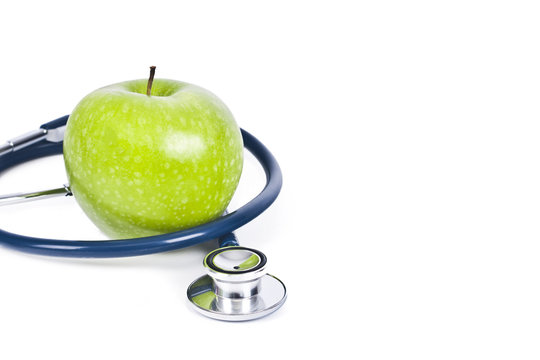 stethoscope and apple isolated on white background