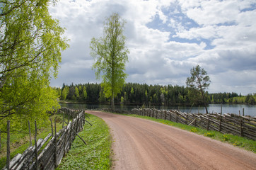 Fototapeta premium Old gravel road by the lake