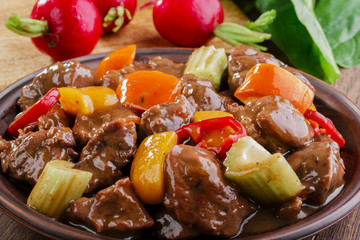 goulash meat with vegetables on the plate