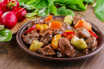 goulash meat with vegetables on the plate