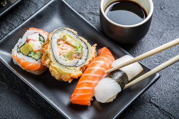 Closeup of sushi served in the dark ceramics