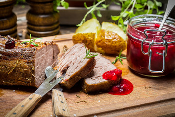 Venison with rosemary served with cranberry sauce