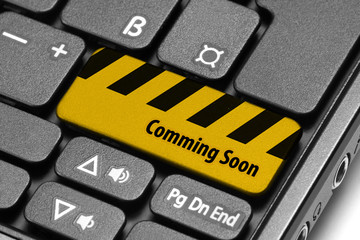 Comming Soon. Yellow warning key on computer keyboard