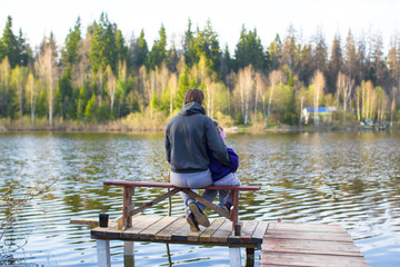 Young dad and little girl fishing on the lake