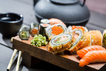 Fototapeta na wymiar Closeup of fresh sushi on wooden board