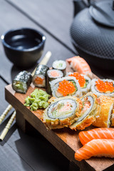 Fresh sushi on wooden board served with tea