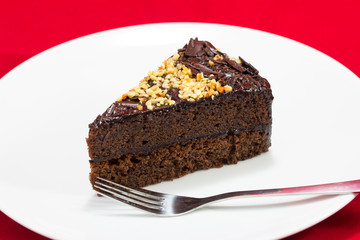 Chocolate cake slice isolated on white plate