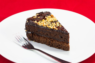 Fototapeta na wymiar Chocolate cake slice isolated on white plate