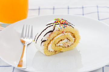 Homemade roll cake on white plate