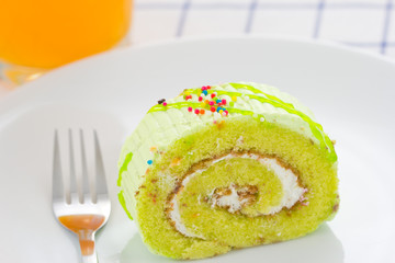 Homemade roll cake on white plate