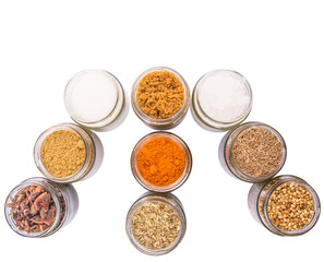 Different variety of sugar and spices over white background
