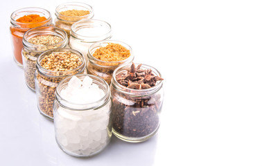 Different variety of sugar and spices over white background