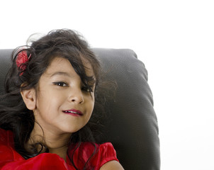 A cute girl sitting on sofa