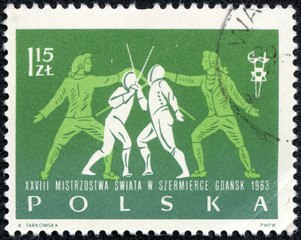 stamp printed in Polska shows two fighting fencers