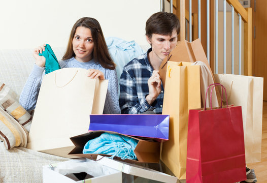 Woman showing purchases  to boyfriend