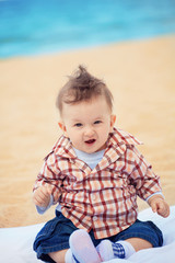 Fototapeta premium excited baby boy on the beach