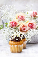 Chocolate cupcakes for wedding reception. Bouquet of pink roses