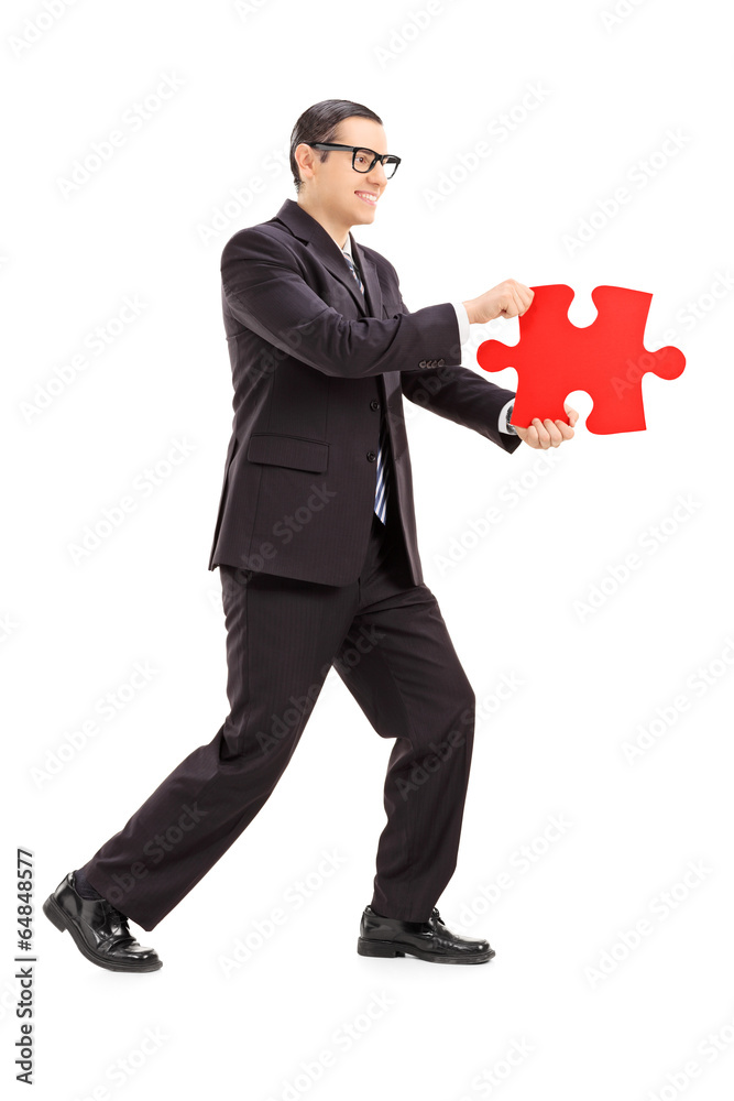 Poster Businessman holding a piece of puzzle