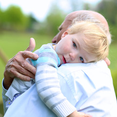 Grandfather comforting his little sad grandchild