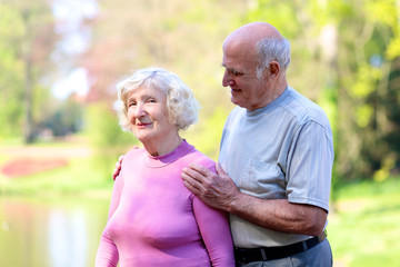 Portrait of happy loving senior couple outdoors in nature