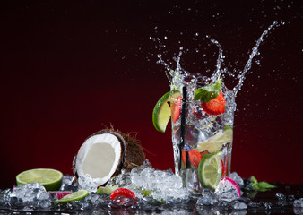 Naklejka na ściany i meble Fresh fruit cocktail in freeze motion splashing