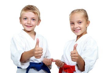 Boy and girl in karategi are showing thumb super © andreyfire