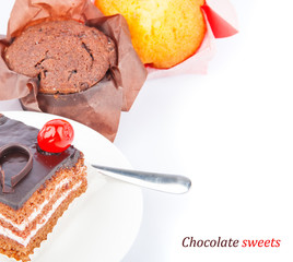 Chocolate cherry cake on plate and cupcake
