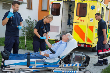Emergency team examining patient on stretcher