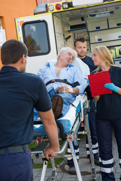 Paramedical team helping injured man on stretcher