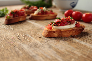 Fresh bruschetta with tomato, mozzarella cheese and herbs