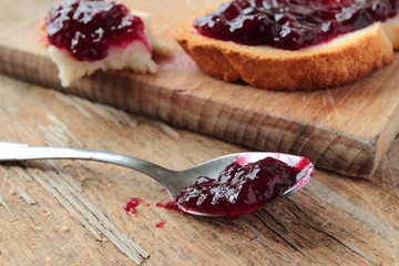 Spoon with sweet blackcurrant jam for breakfast