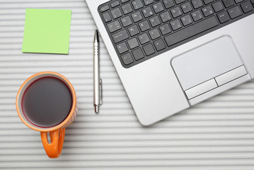 laptop computer on desk with cup of tea