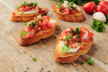 Fresh antipasto called bruschetta with tomato, garlic and cheese