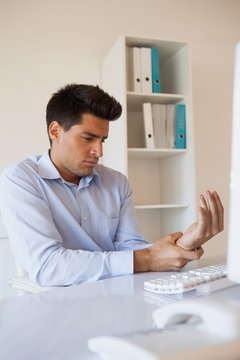 Casual Businessman Touching His Sore Wrist