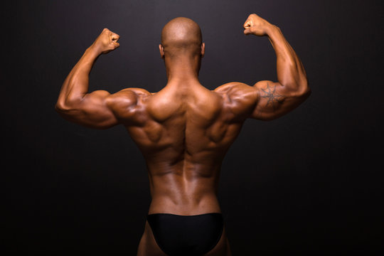 rear view of afro american male bodybuilder posing