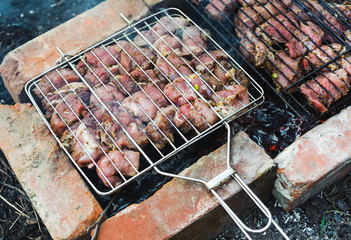 many roast meat pieces on a grill