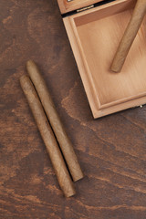 two cigars and a box on an old table