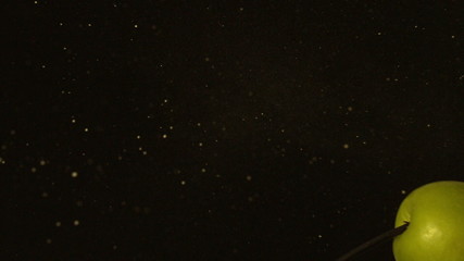 Arrow shooting through green apple on black background - Powered by Adobe