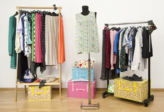 Closet with polka dots clothes arranged on hangers and mannequin