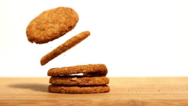 Biscuits falling on wooden table