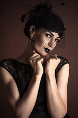 Beauty Fashion Model with Black Makeup isolated on brown