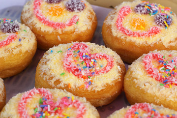 A lot of donuts and strawberry jam