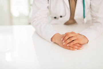 Closeup on medical doctor woman sitting at table