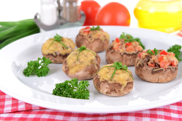 Stuffed mushrooms on plate on table close-up